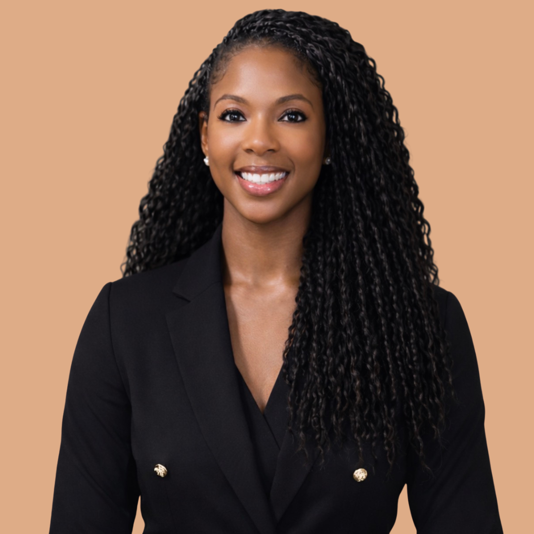 Cortney Adams smiling at the camera. Peach colored background